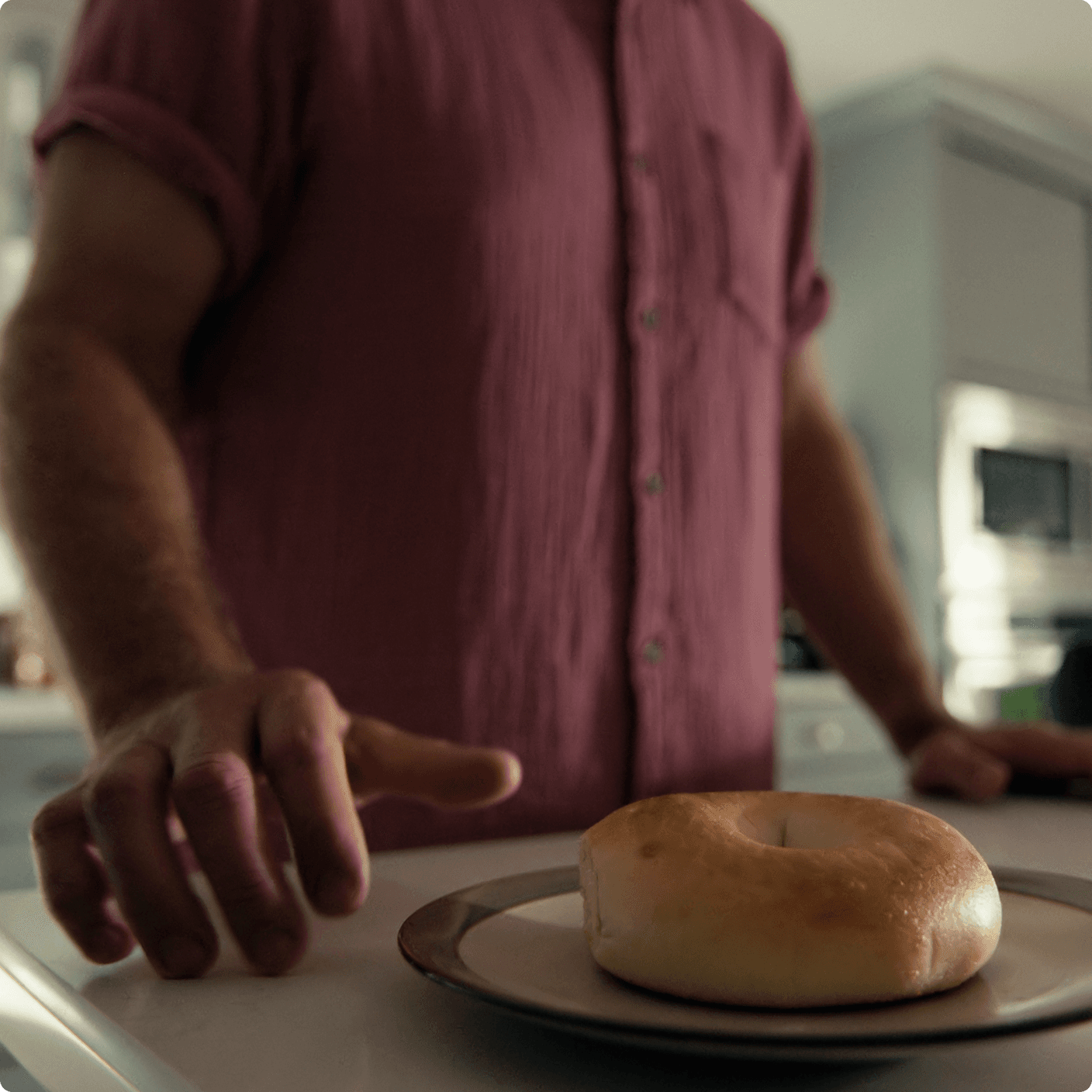 Ben is reaching for a bagel. 