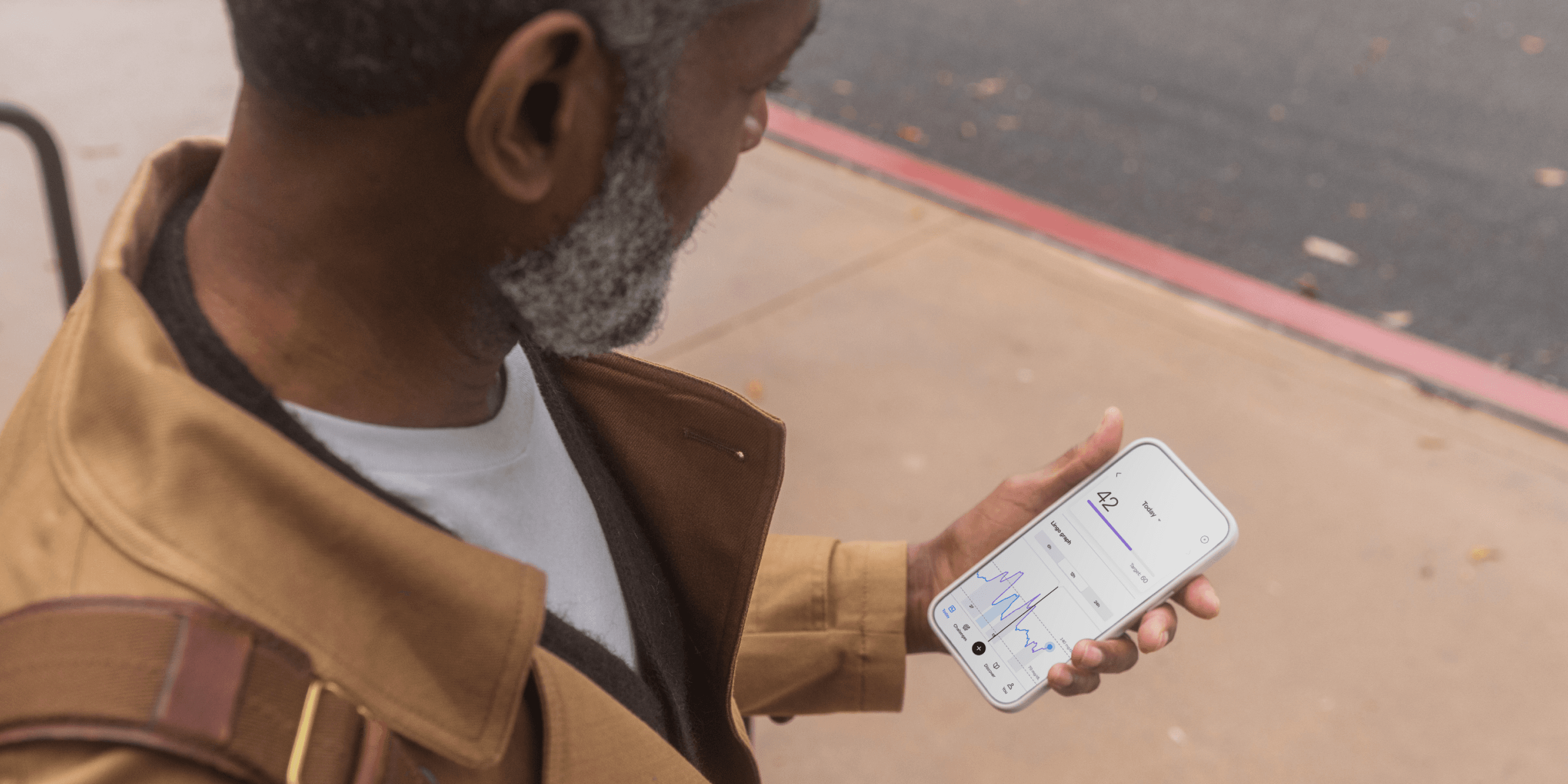 Man looking at Lingo app. 