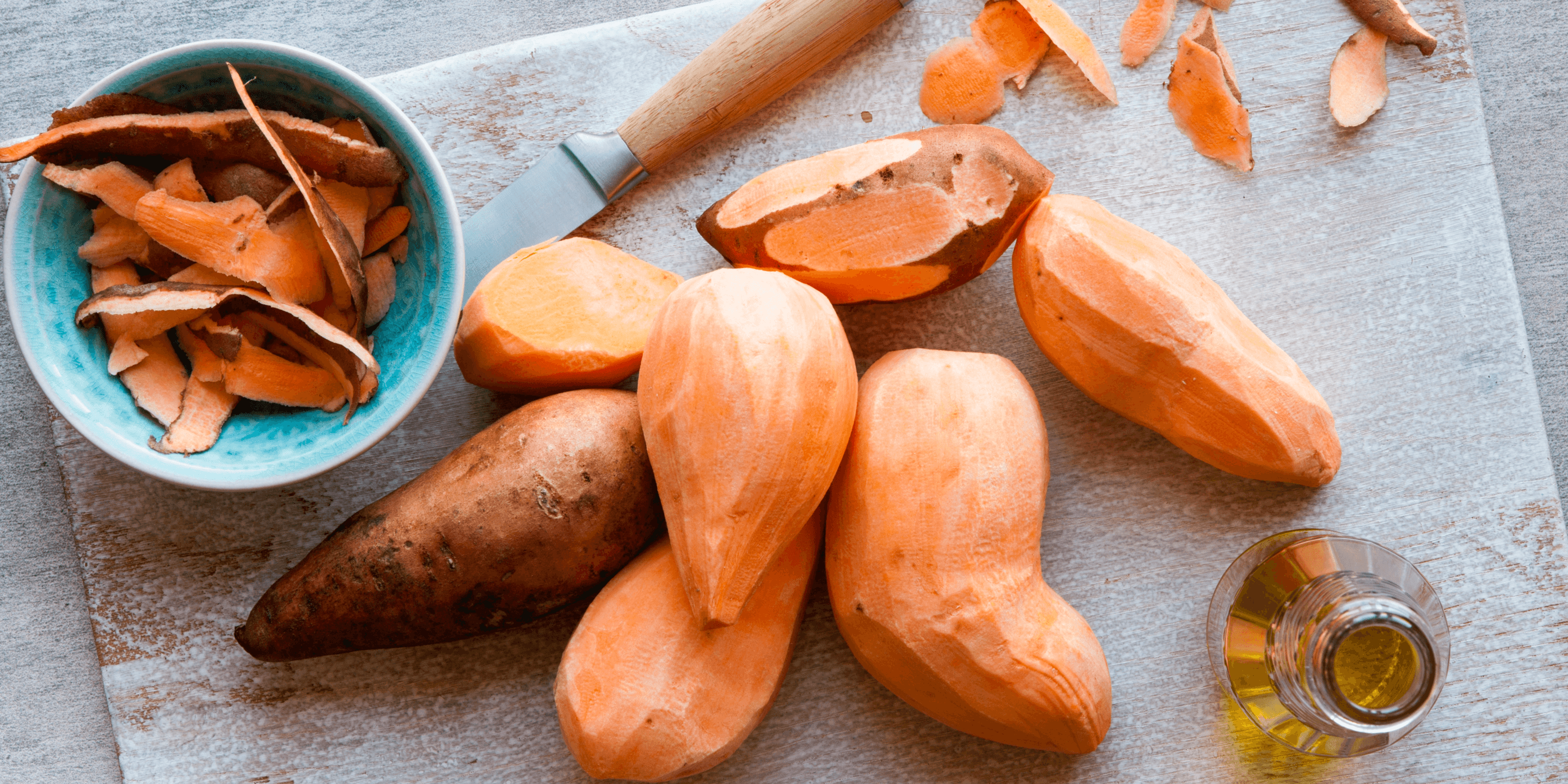 Sweet potatoes on board for peeling. 
