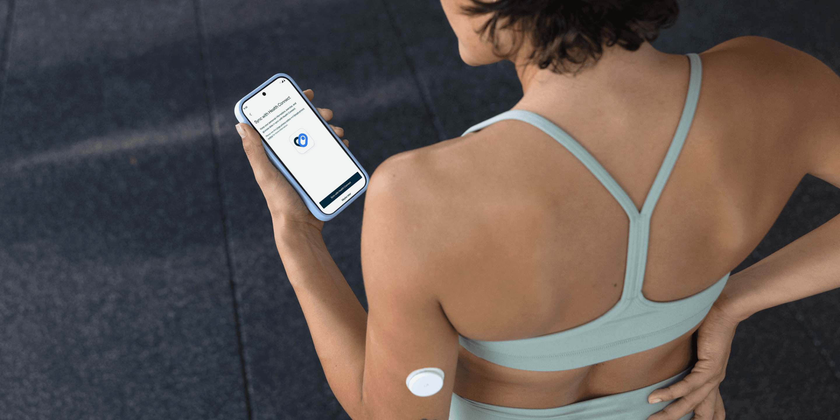 Person wearing a CGM looks at Lingo app on phone