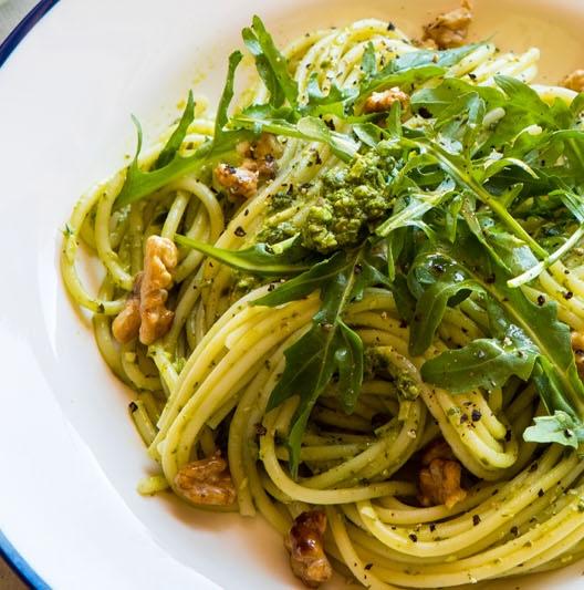 Spaghetti, rocket, pesto, and walnuts