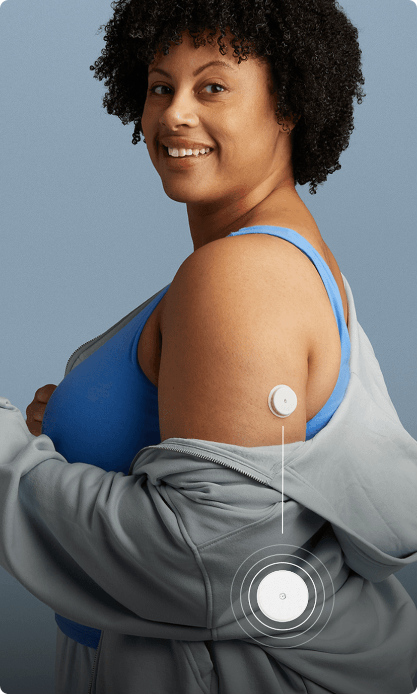 Woman in a sleeveless shirt wearing a Lingo biosensor