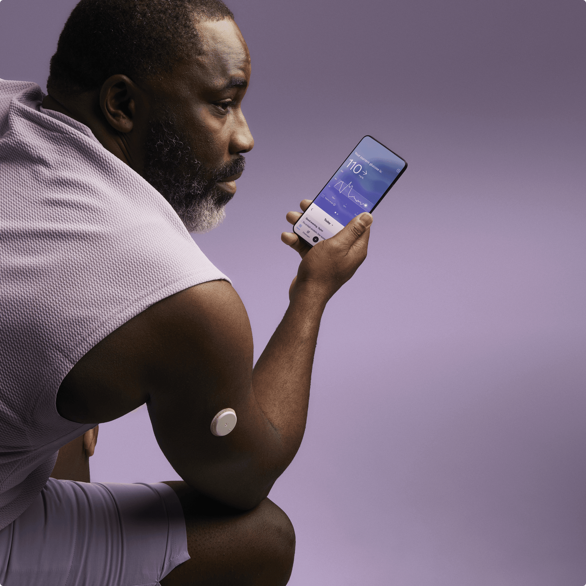 A man wearing a Lingo sensor looking at his phone