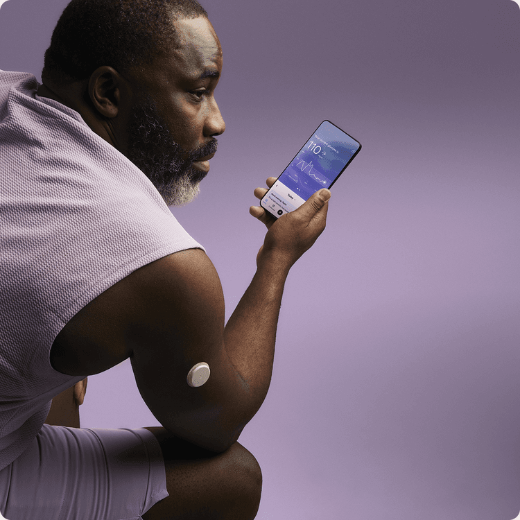 A man wearing a Lingo sensor looking at his phone