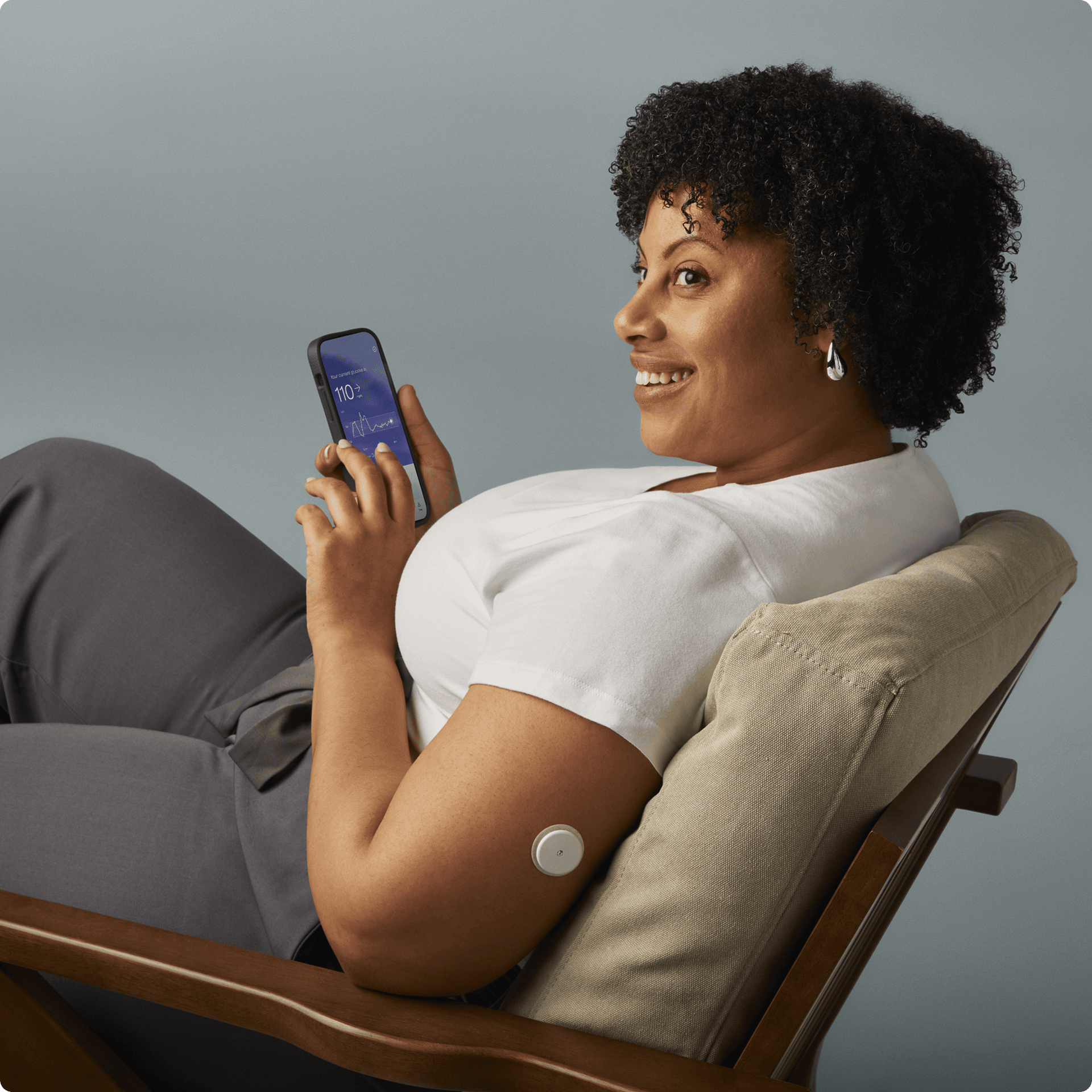 A man sitting in a chair wearing a lingo biosensor