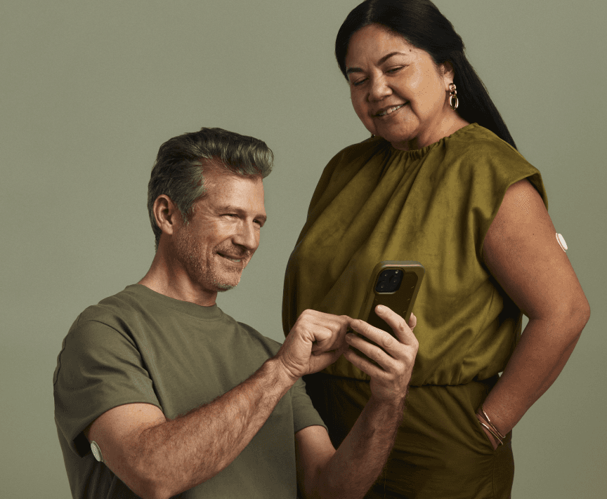 Man sitting looking at the Lingo app on his phone.
