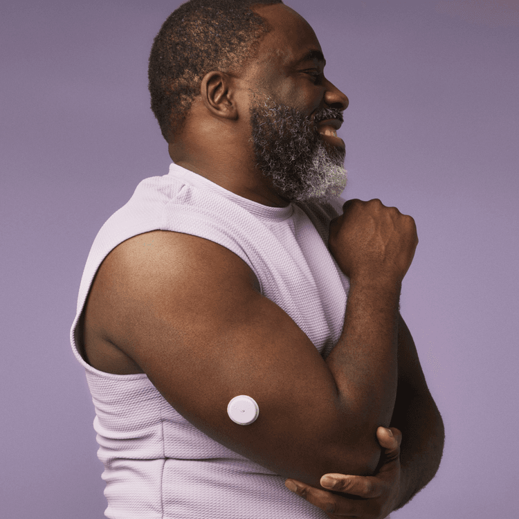 Smiling man flexing his arm showing his Lingo biosensor