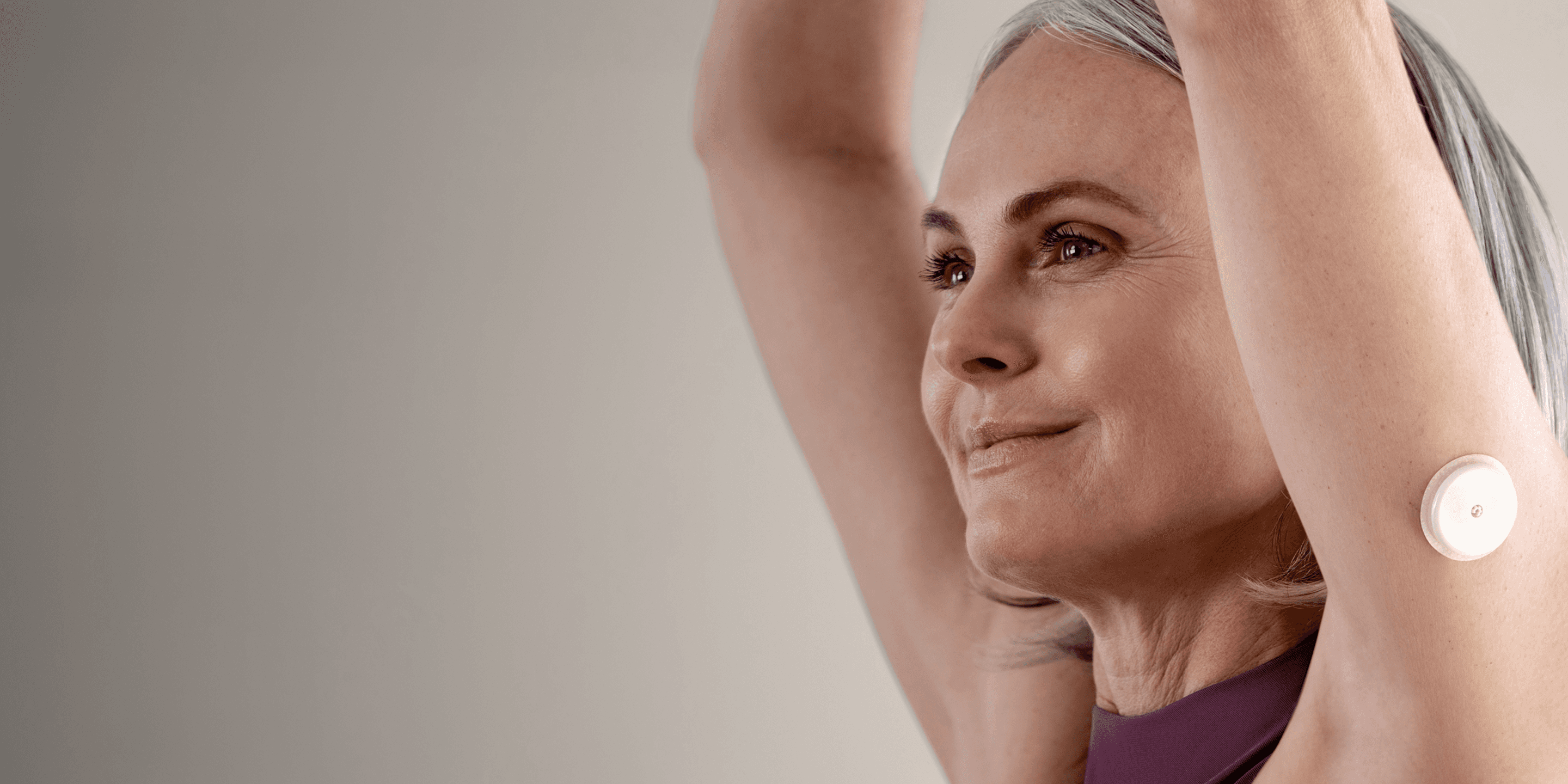 A woman wearing a Lingo Continuous Glucose Monitor