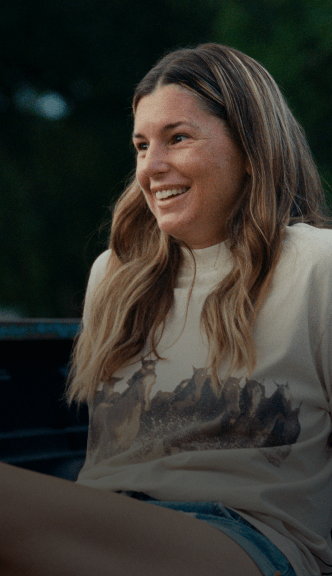 Woman sitting on a truck bed.