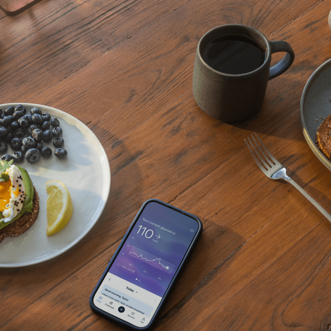Two breakfasts with phone showing Lingo app.