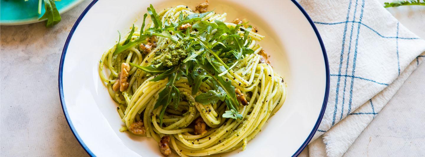 Spaghetti, rocket, pesto, and walnuts