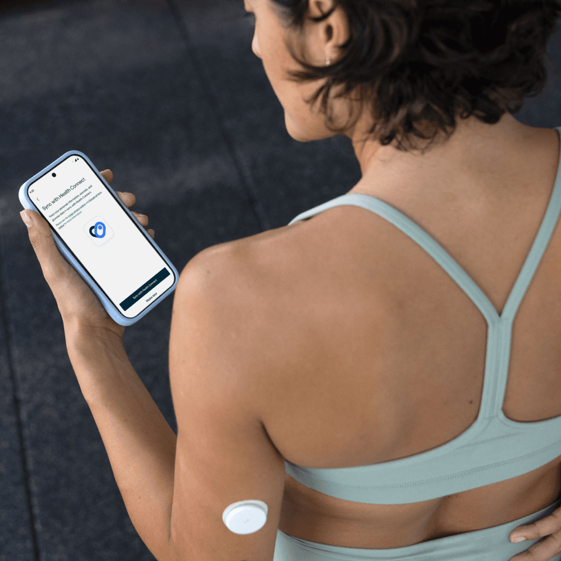 Person wearing a CGM looks at Lingo app on phone