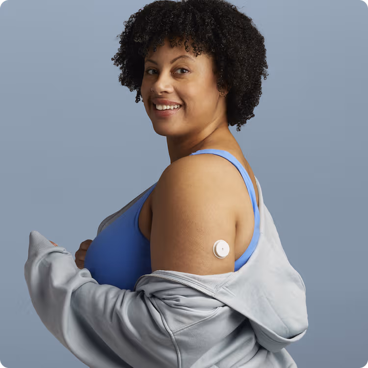 A woman wearing a Lingo Continuous Glucose Monitor