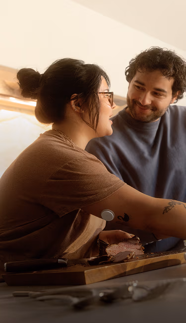A couple making a meal together in their kitchen.