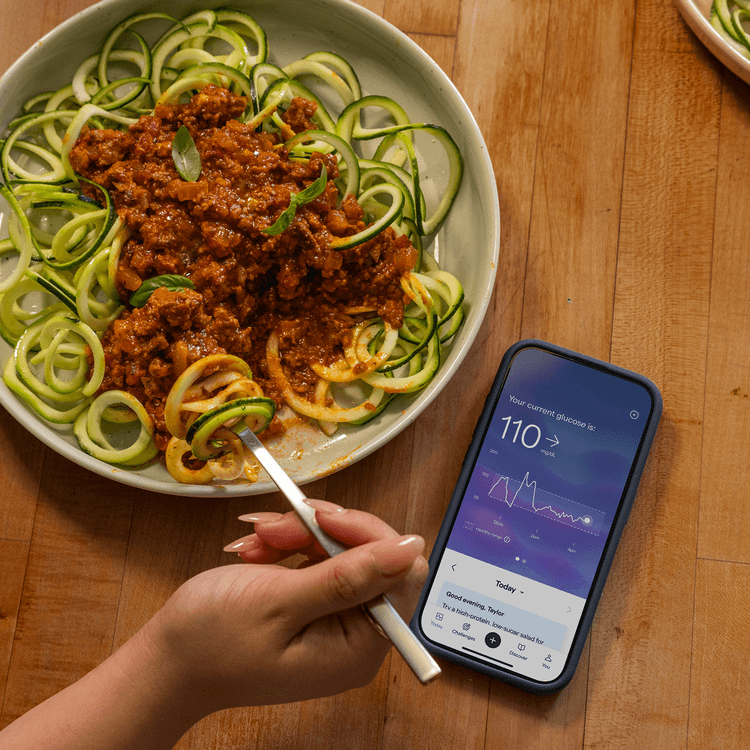 Looking at Lingo app on phone while eating zoodles