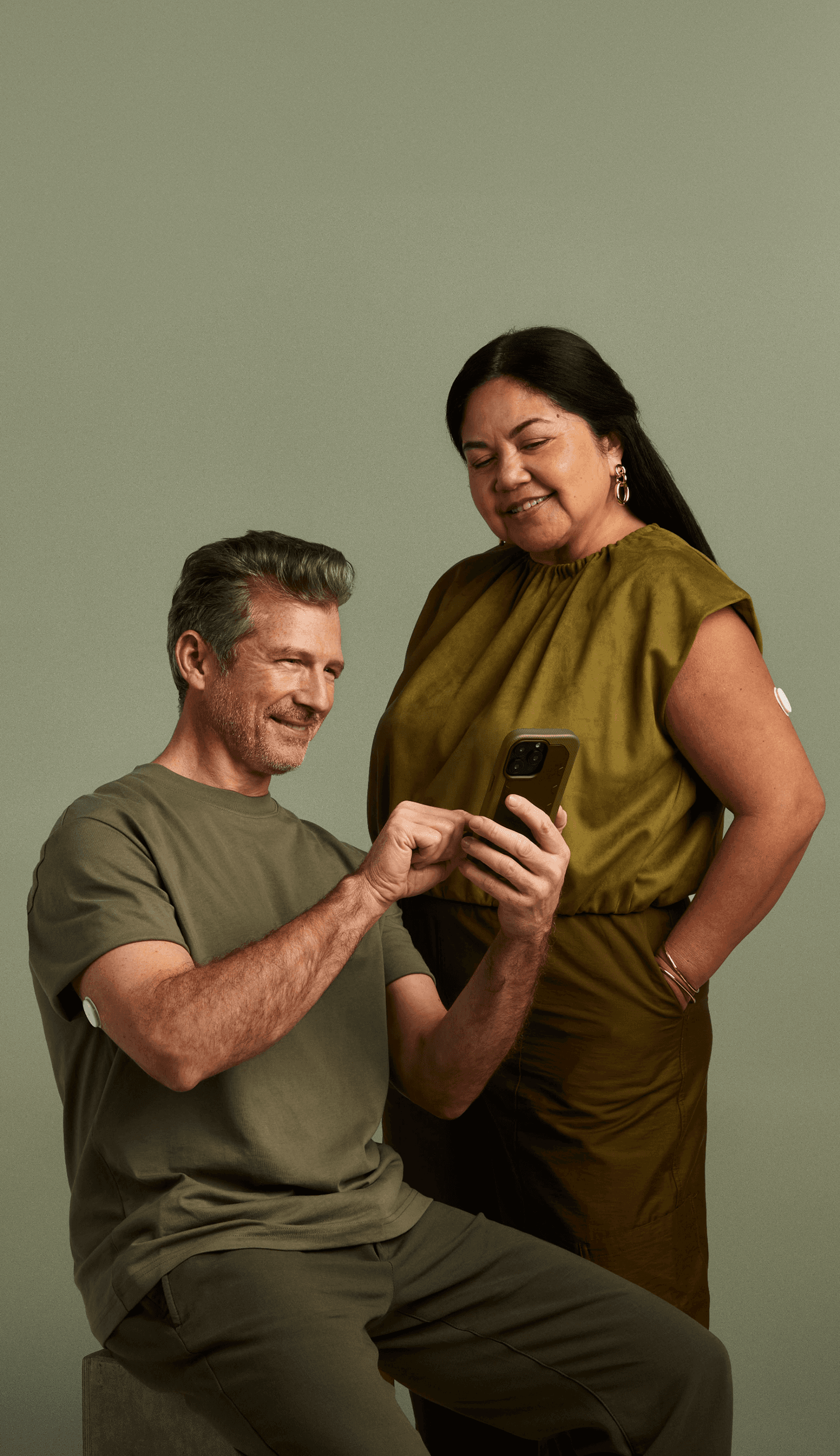 A man and woman standing together wearing Lingo biosensors