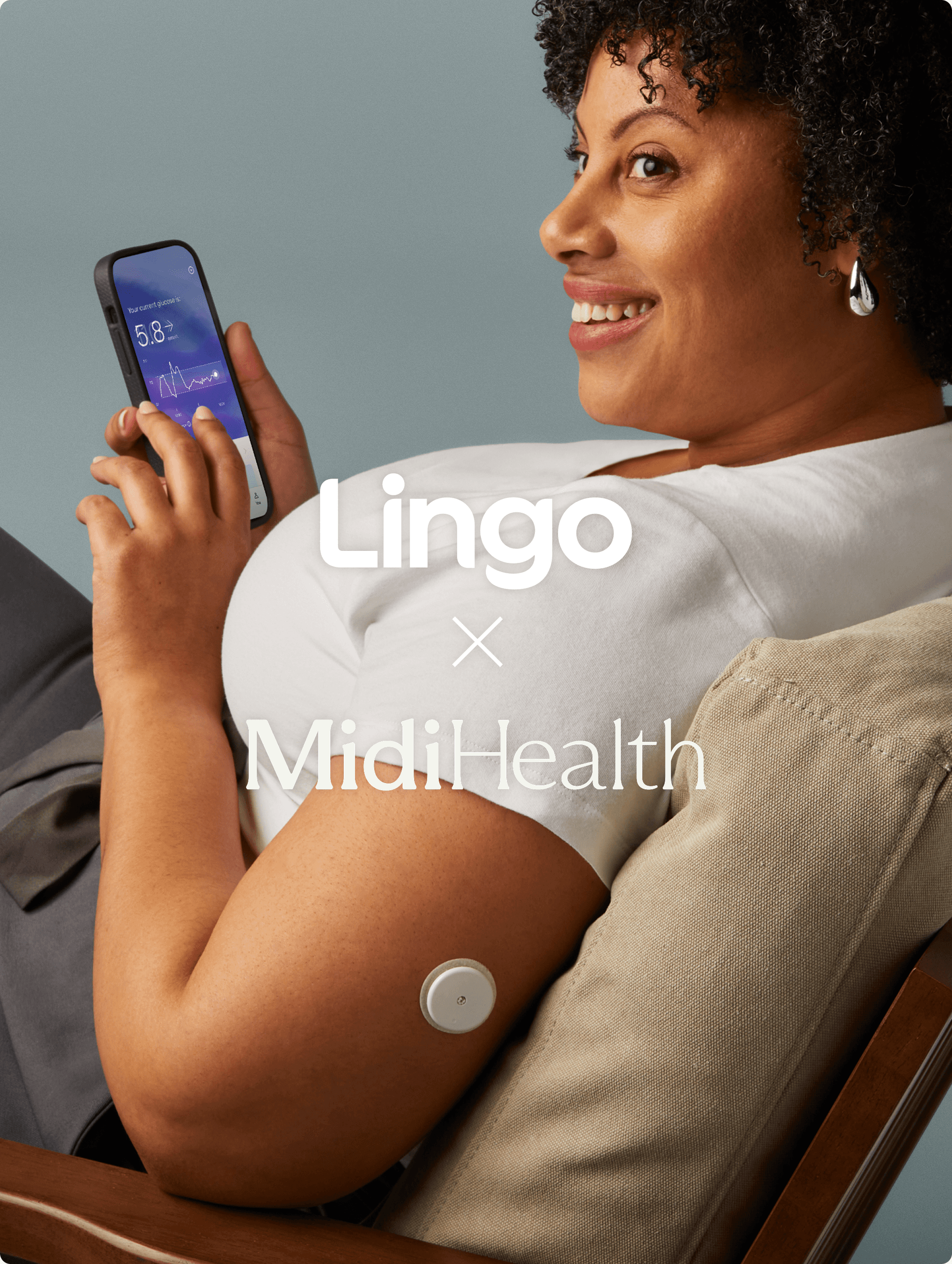A smiling woman sitting looking at her Lingo app.