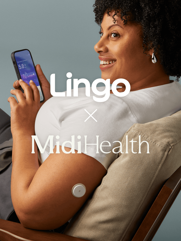 A smiling woman sitting looking at her Lingo app.