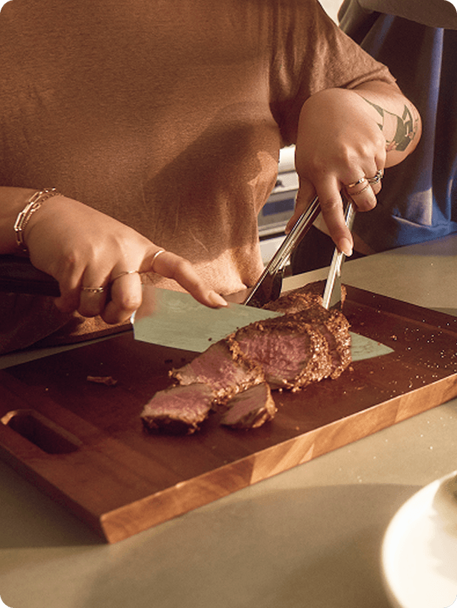 Woman cutting steak