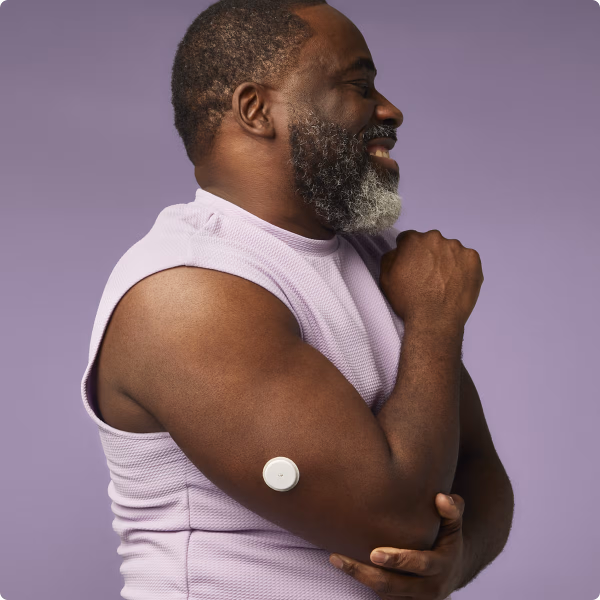 Smiling man flexing his arm showing his Lingo biosensor