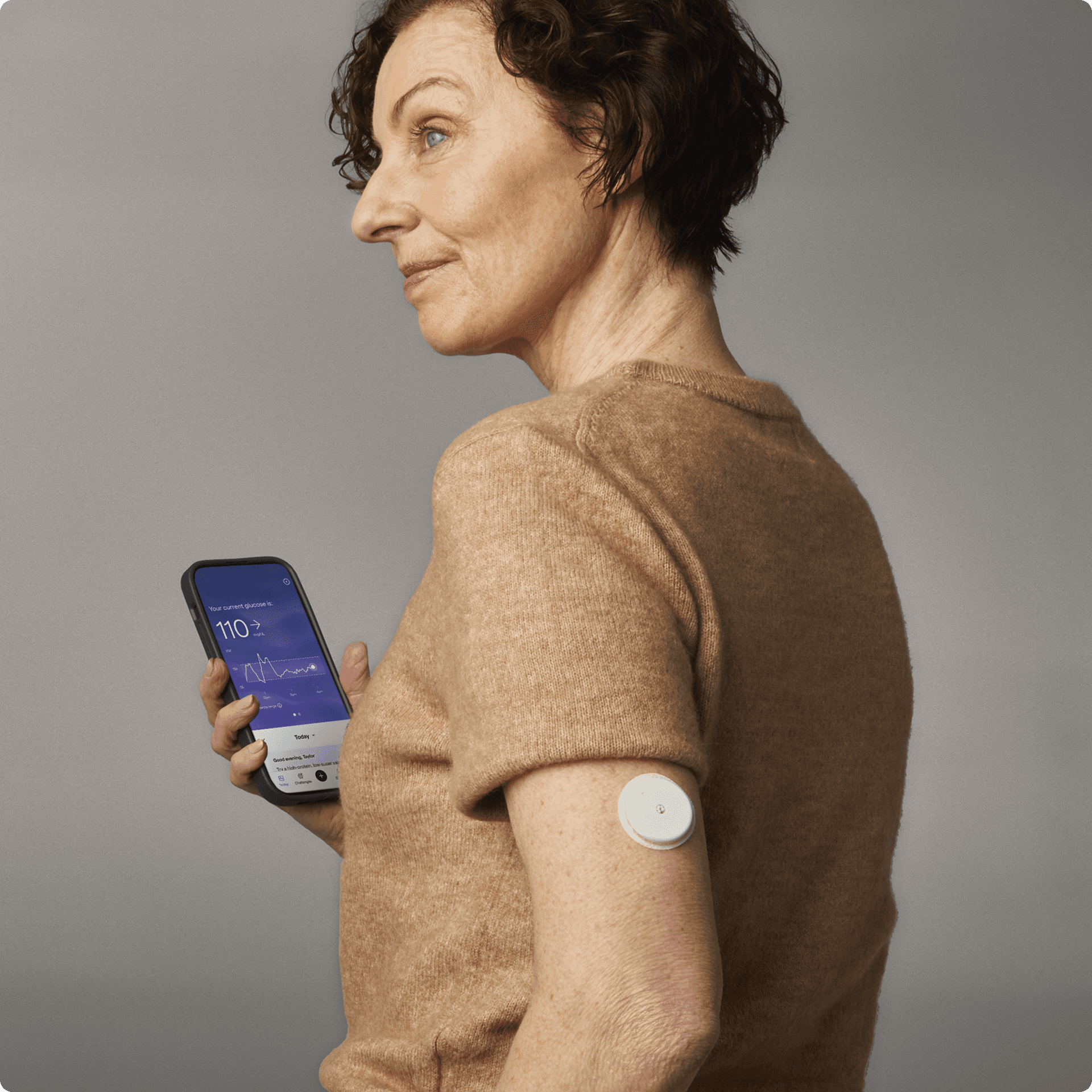 A woman holding her phone with the Lingo app on her screen