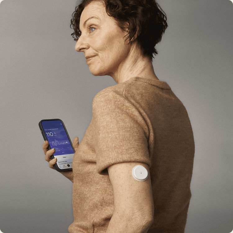 A woman holding her phone with the Lingo app on her screen