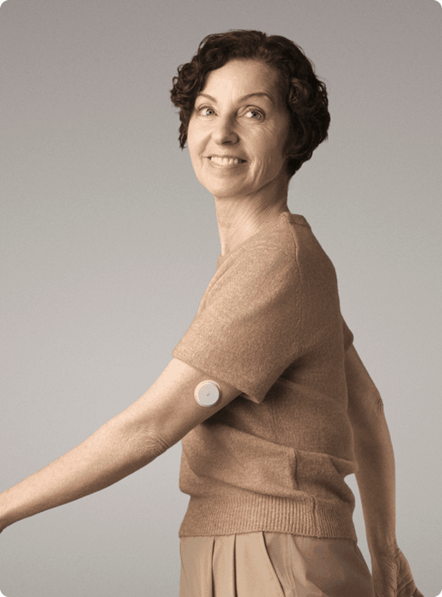 A woman wearing a Lingo Continuous Glucose Monitor