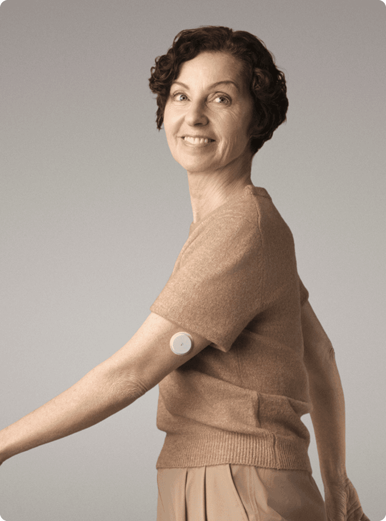 A woman wearing a Lingo Continuous Glucose Monitor