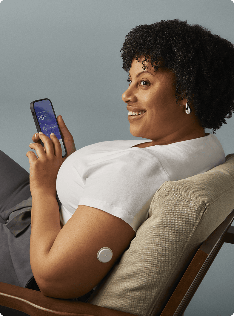A woman wearing a Lingo Continuous Glucose Monitor