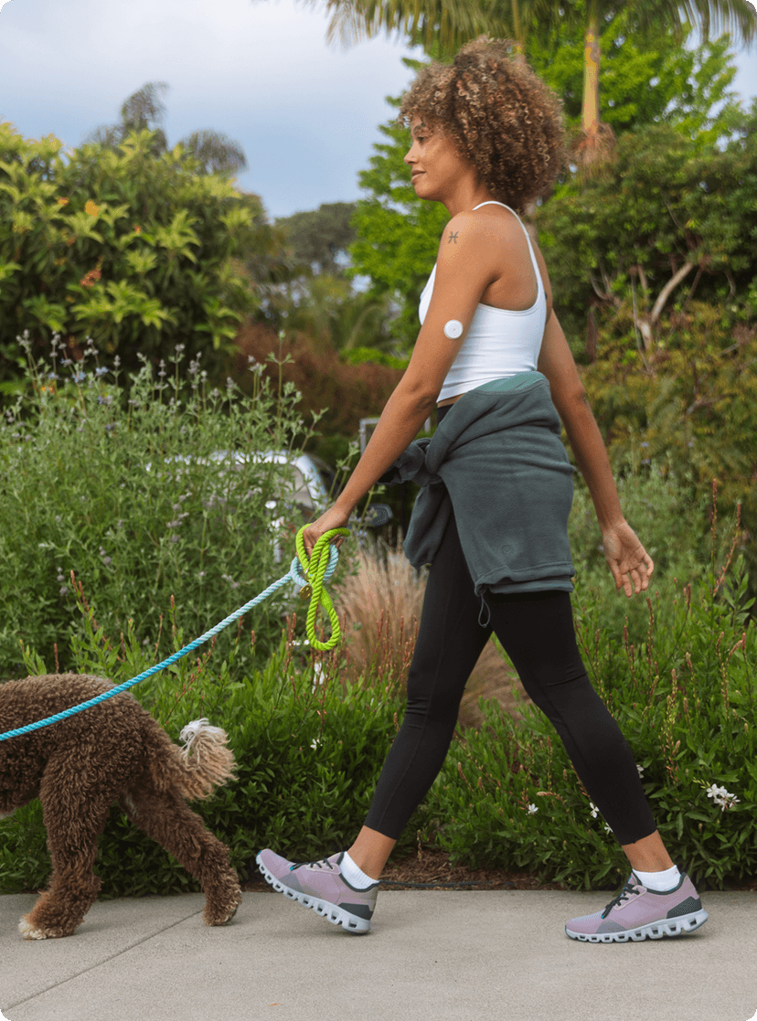 A woman talking a walk with her dog