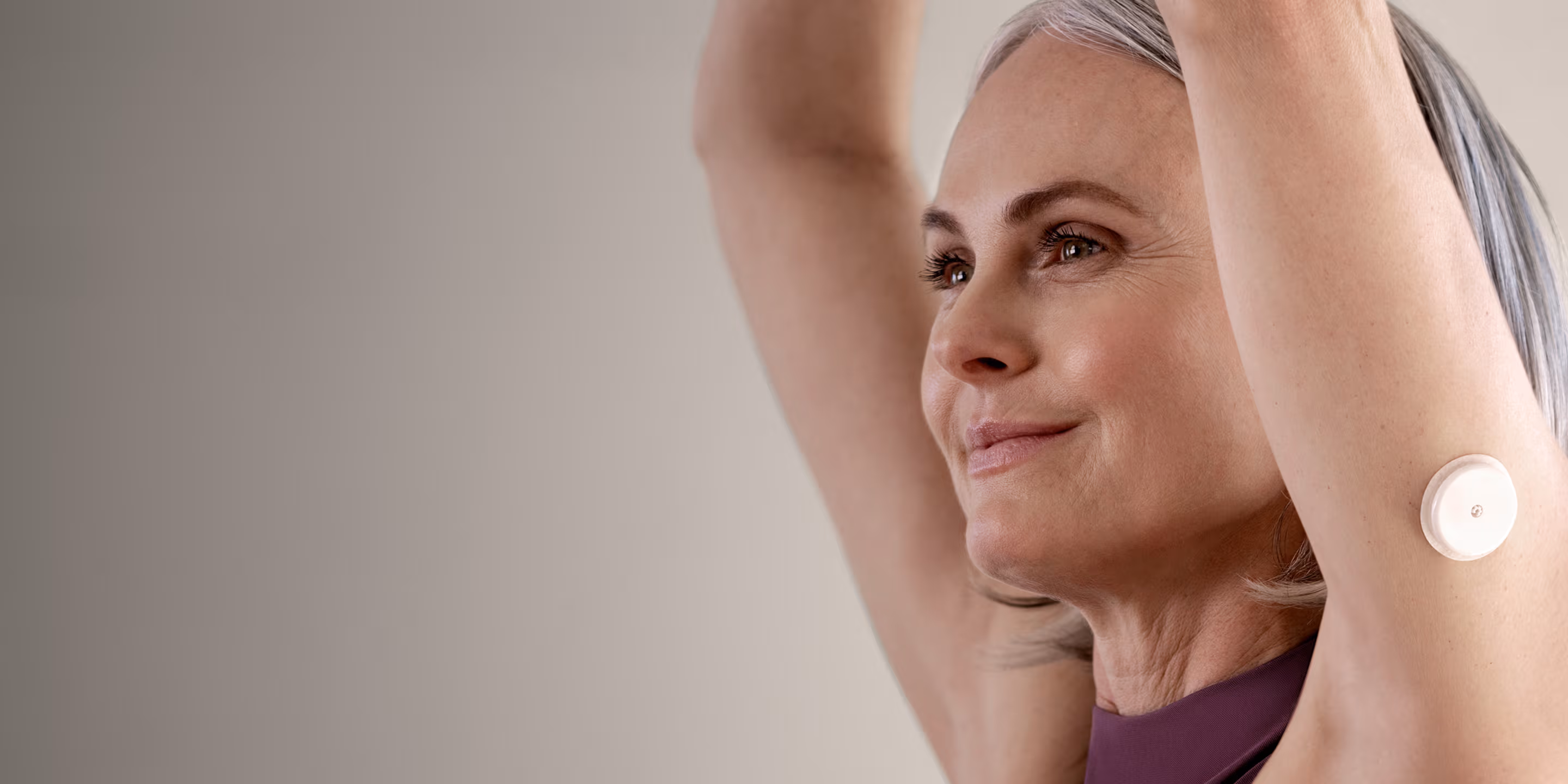 A woman wearing a Lingo Continuous Glucose Monitor