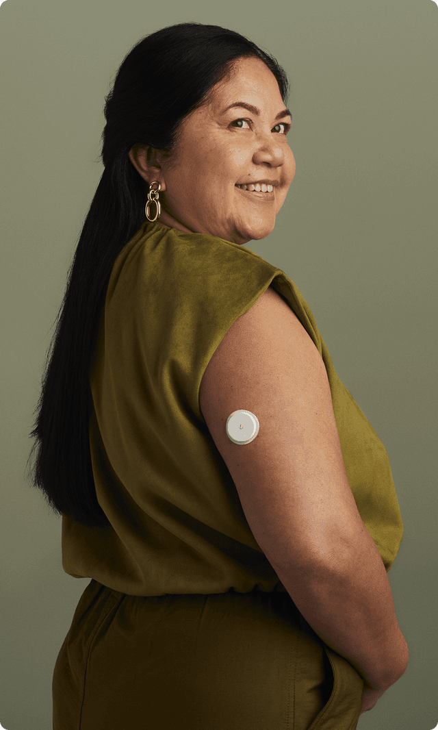 A woman wearing a Lingo Continuous Glucose Monitor