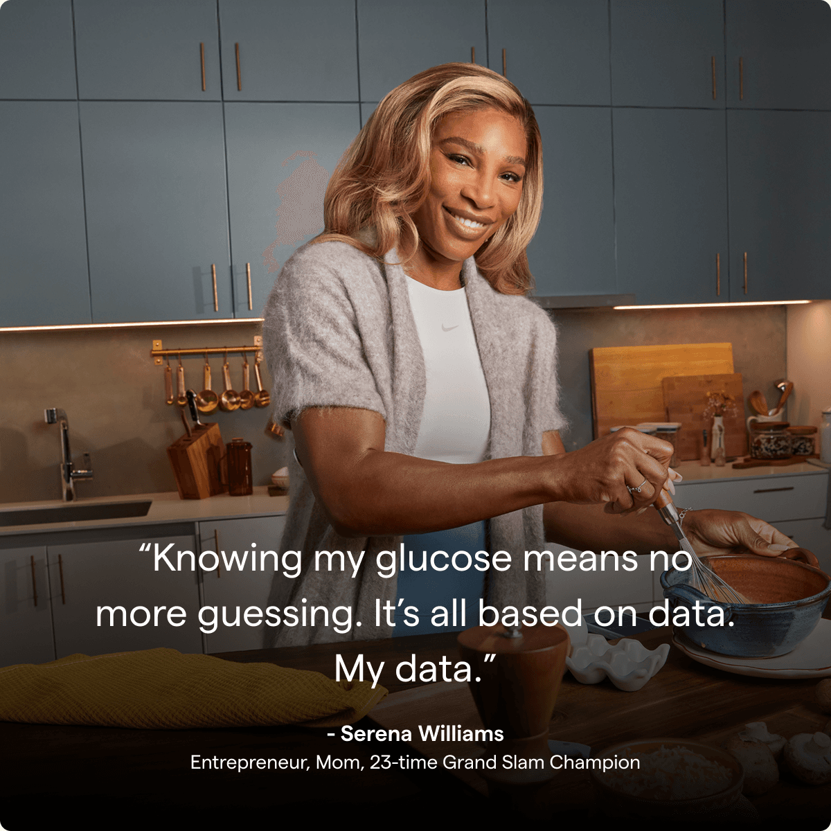 Serena Williams smiling in her kitchen while she cooks.