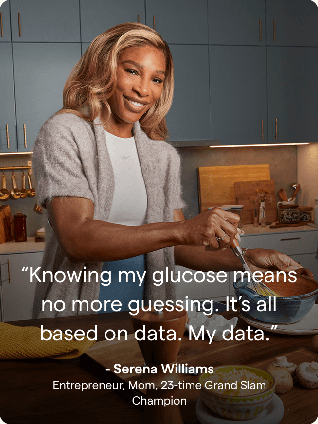 Serena Williams smiling in her kitchen while she cooks.