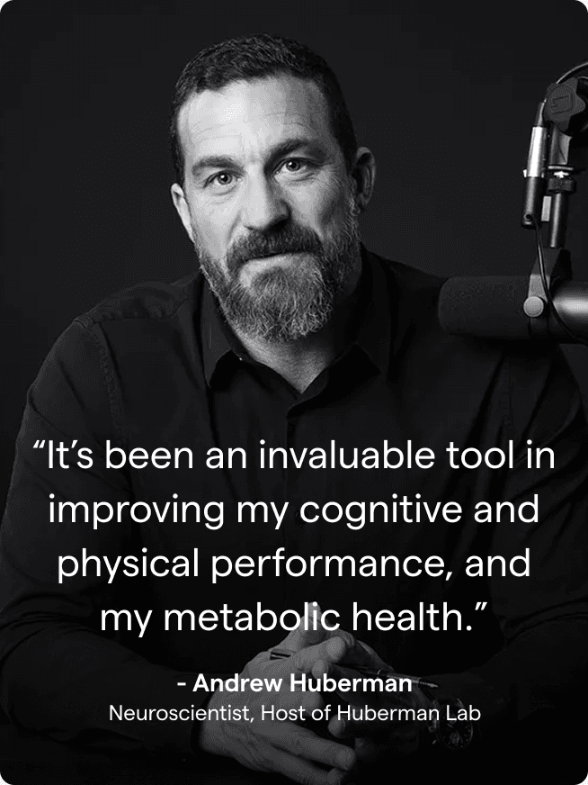 Black and white photo of Andrew Huberman in his podcast studio.