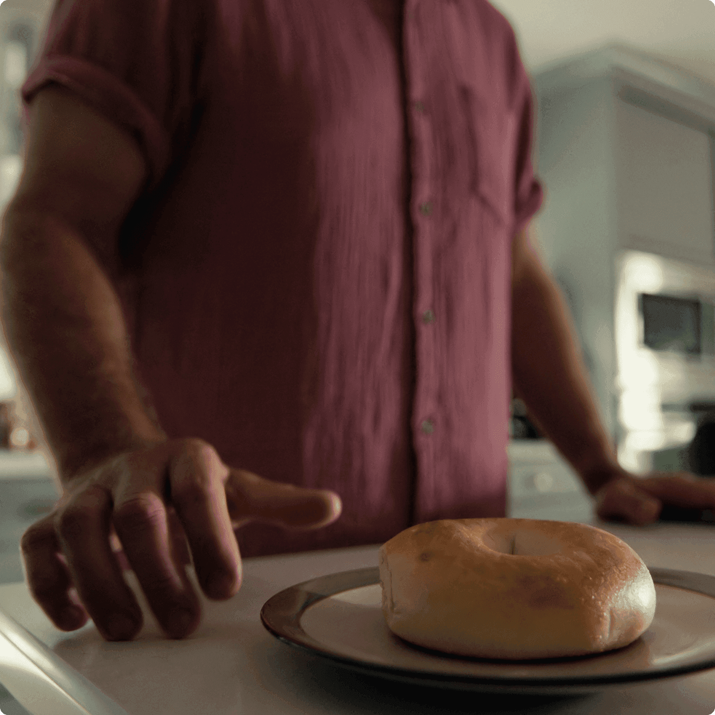 Ben is reaching for a bagel.