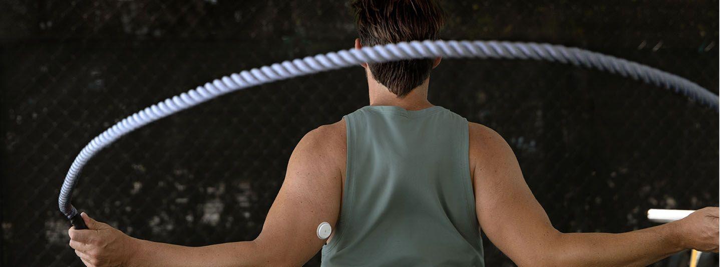 Woman using a jump rope wearing a CGM