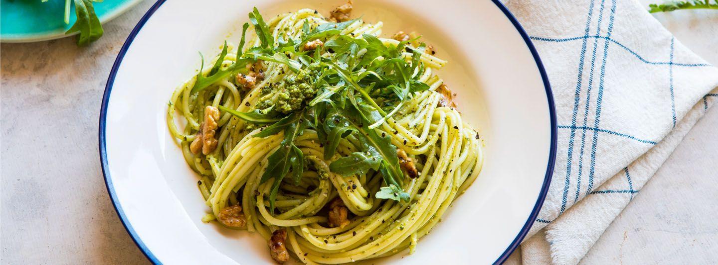Spaghetti, rocket, pesto, and walnuts