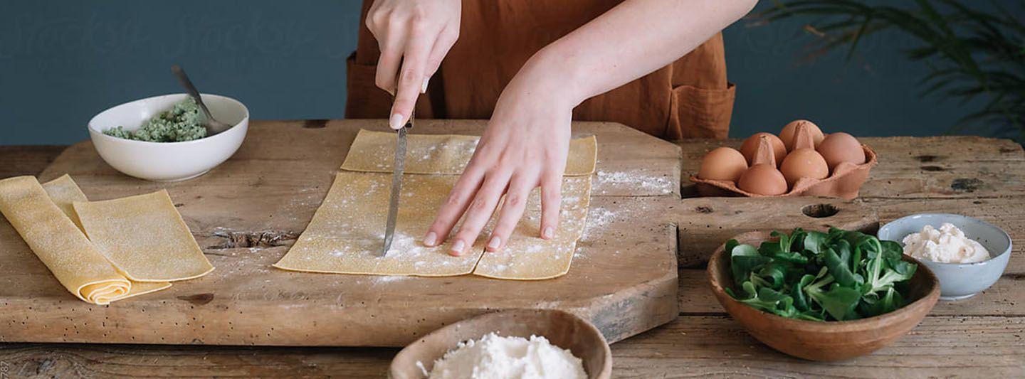 Person cutting pasta sheets
