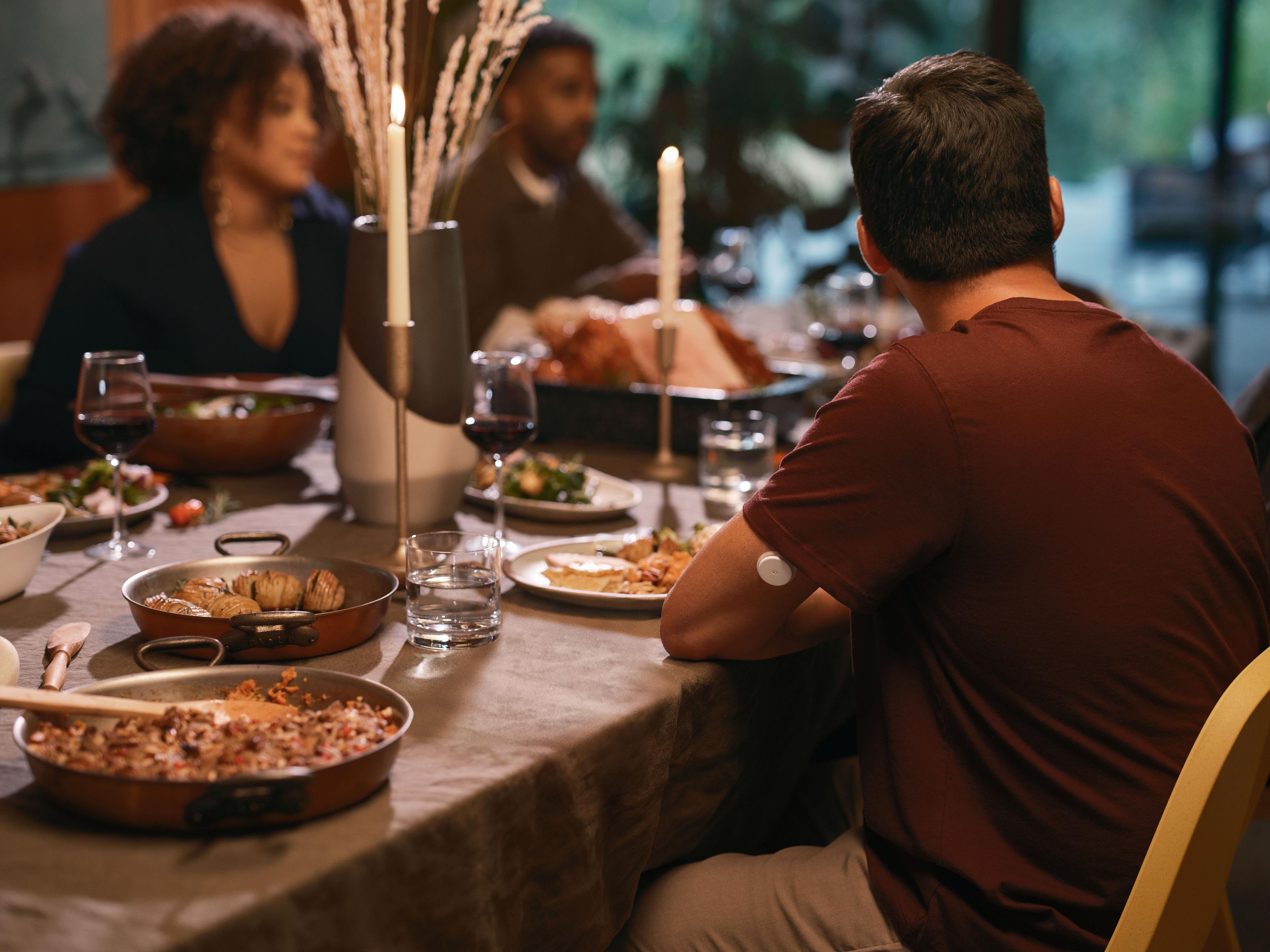 People sitting around a table eating and drinking