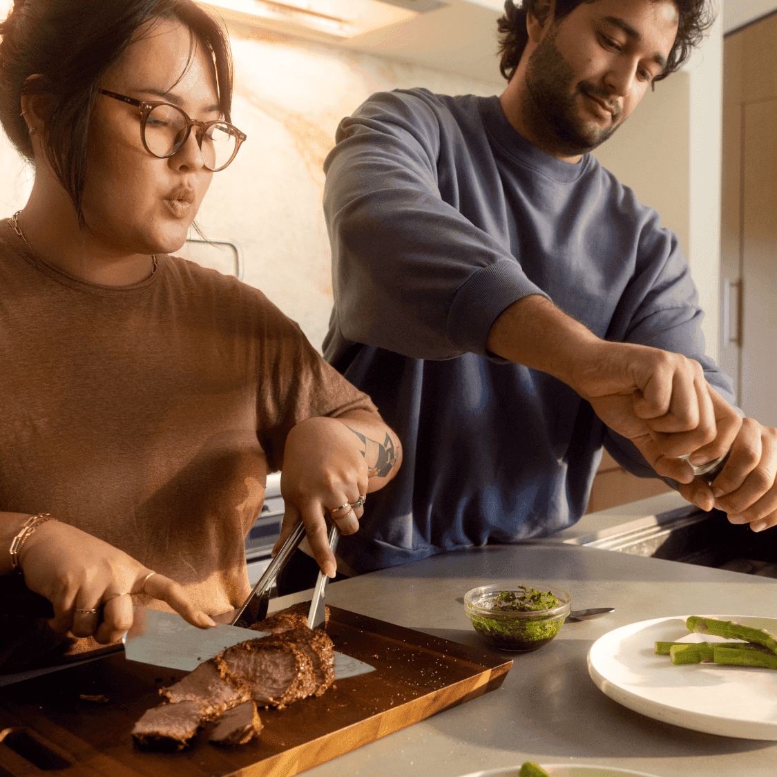 Two adults cooking healthy glucose-friendly meal in kitchen