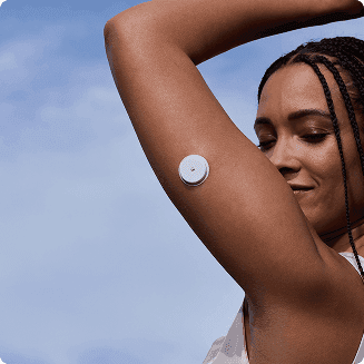 A woman wearing a Lingo Continuous Glucose Monitor
