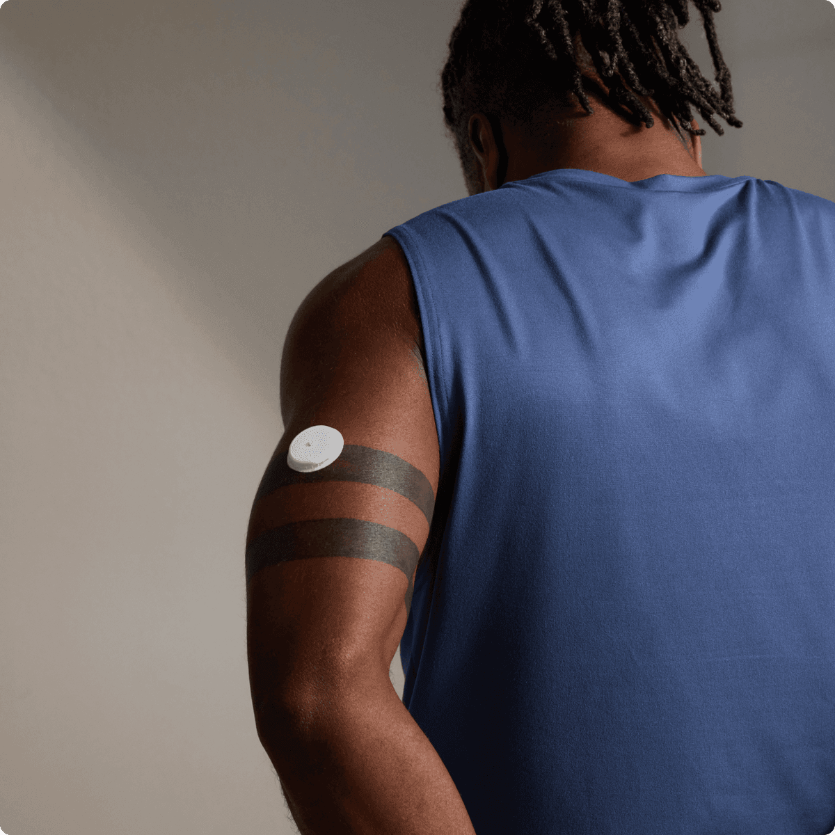 A man facing backwards, wearing a Lingo biosensor